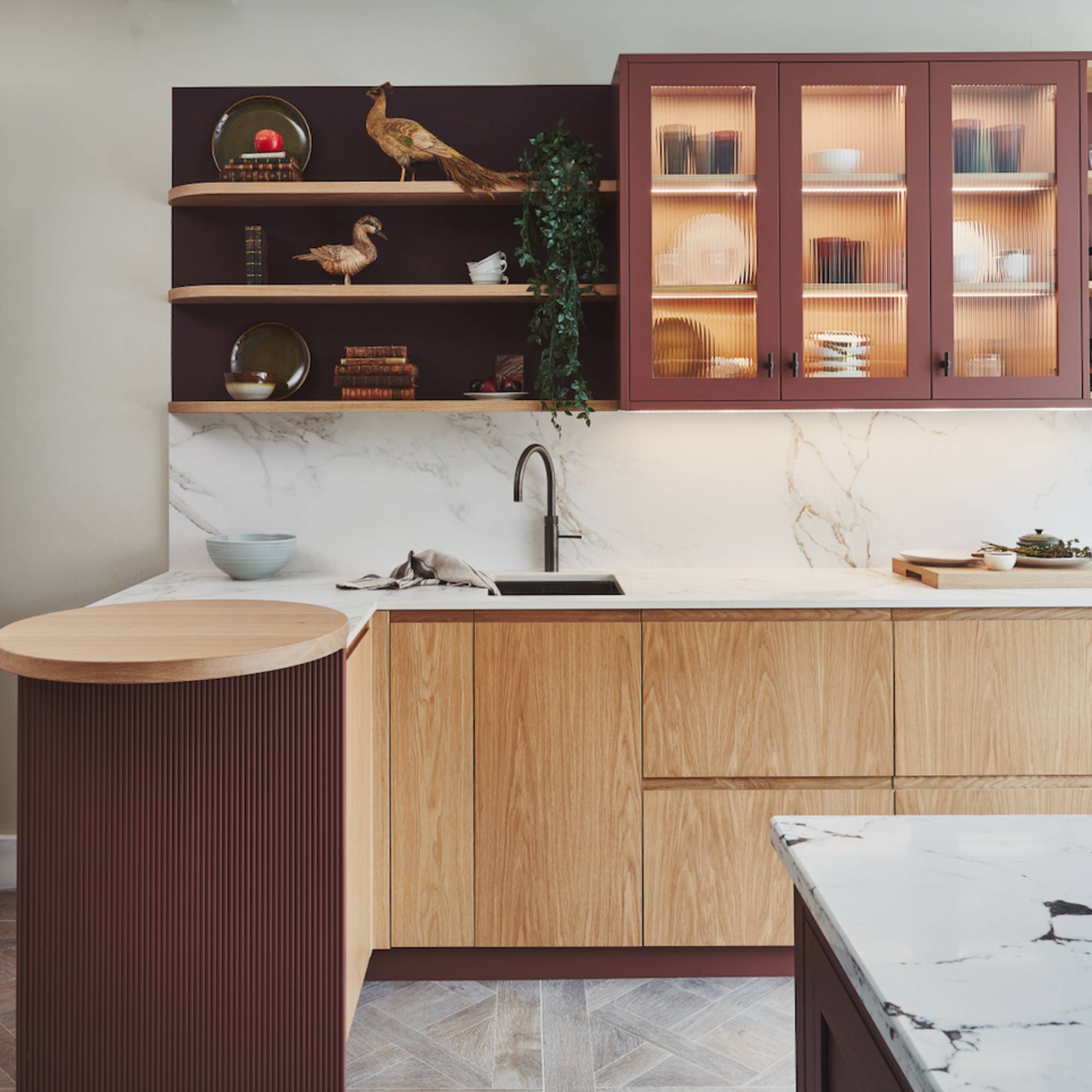 pink and wood kitchen with open shelving and cabinets