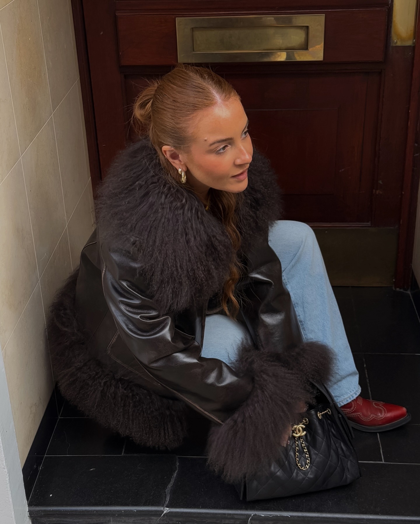 Fashion person Rebecca Ferraz-Wyatt wears a faux fur jacket outfit.