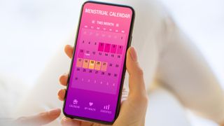 period tracking app in a woman's hand