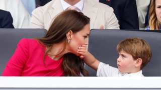 Prince Louis of Cambridge covers his mother Catherine, Duchess of Cambridge's mouth with his hand as they attend the Platinum Pageant on The Mall on June 5, 2022 in London, England