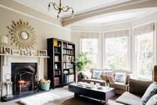 living room with fireplace and bookshelf in period home