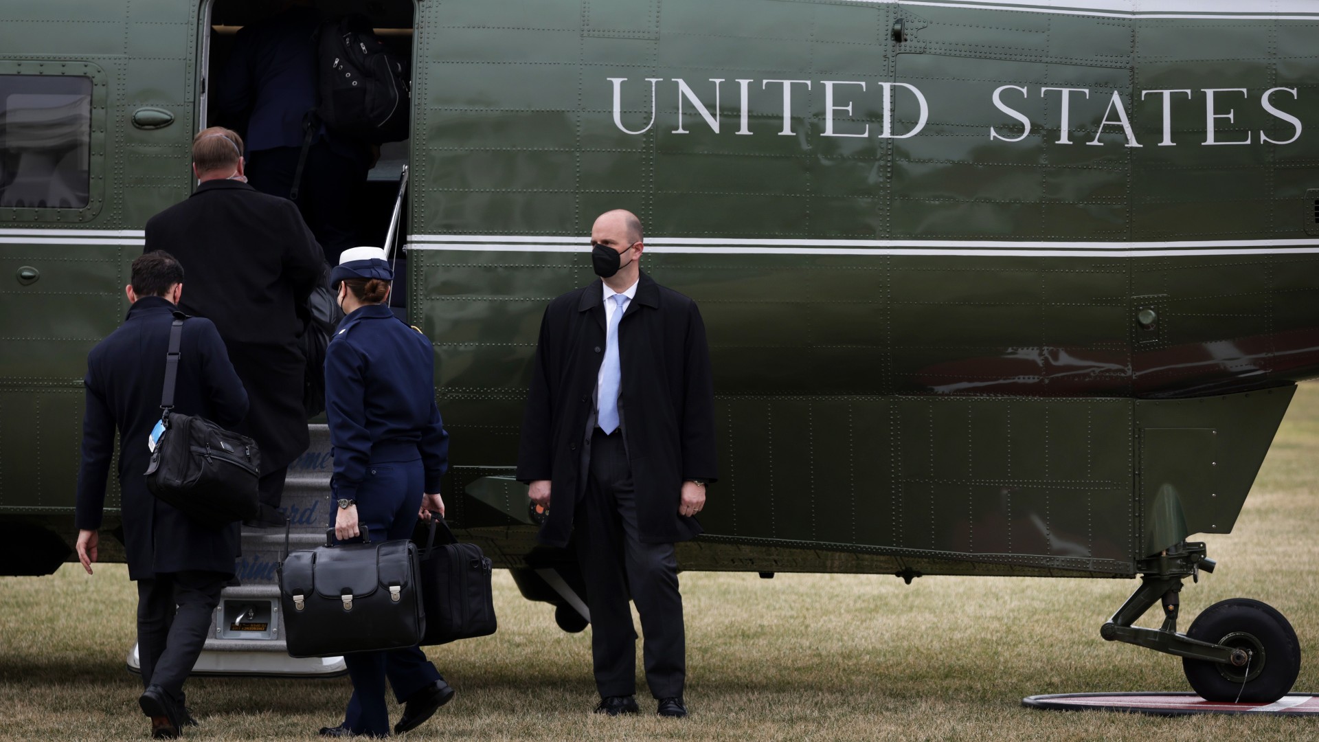 A military aide carries a briefcase, also known as the “nuclear football” with launch codes for nuclear weapons, as she boards Marine One at the White House on February 17, 2022 in Washington, DC. President Biden is traveling to Ohio to highlight a $1 billion investment in environmental cleanup projects in the Great Lakes region.