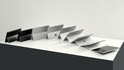 Microsoft Surface devices lined up on desk, showing evolution of the range
