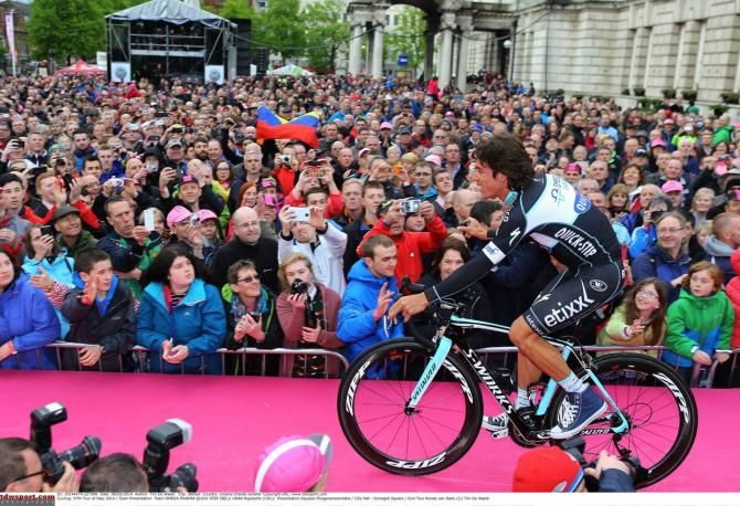 Uran rides past the huge crowd