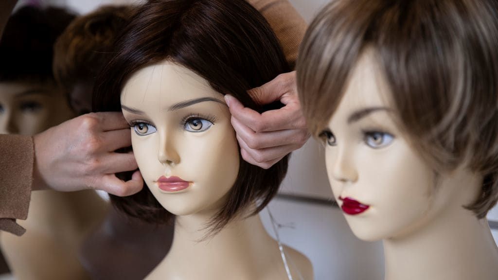 Wigs on mannequin heads.