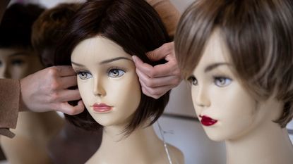 Wigs on mannequin heads.