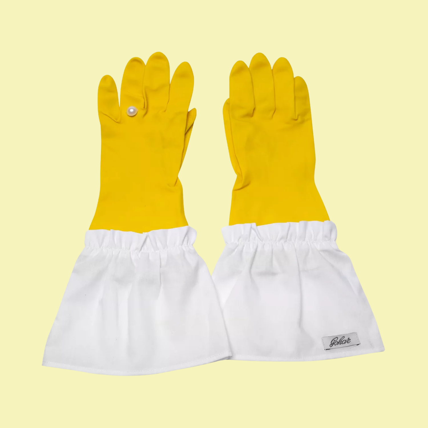A pair of yellow rubber lace trim gloves with a pearl embellishment
