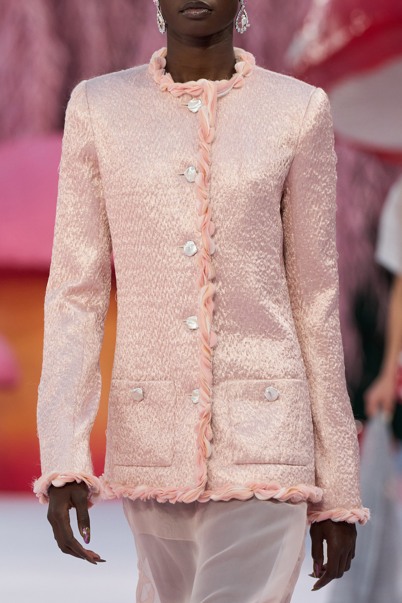 Image of the Chanel Spring Summer 2026, Haute Couture runway show. The model wears a blush pink jacket
