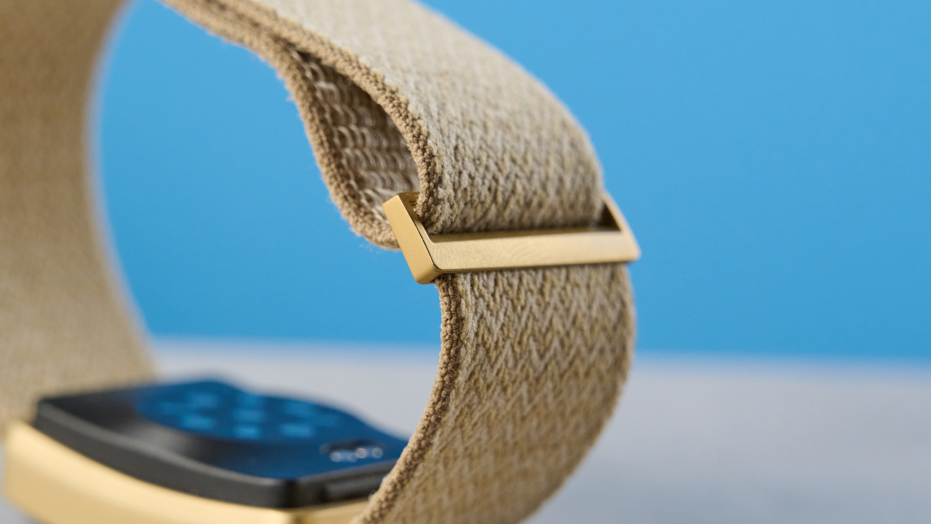 the luna band in beige photographed with the blue tom's guide background being worn by the author