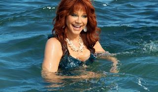 Barb and Star Go to Vista Del Mar Reba McEntire smiles as a mermaid