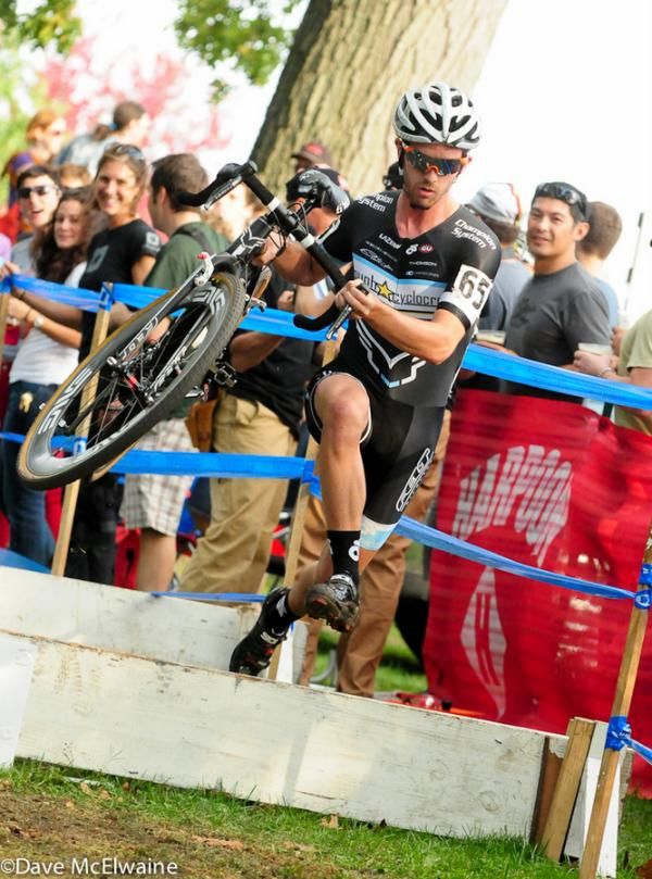 Nick Keough (Keough Cyclocross) running the barriers in front of the beer garden