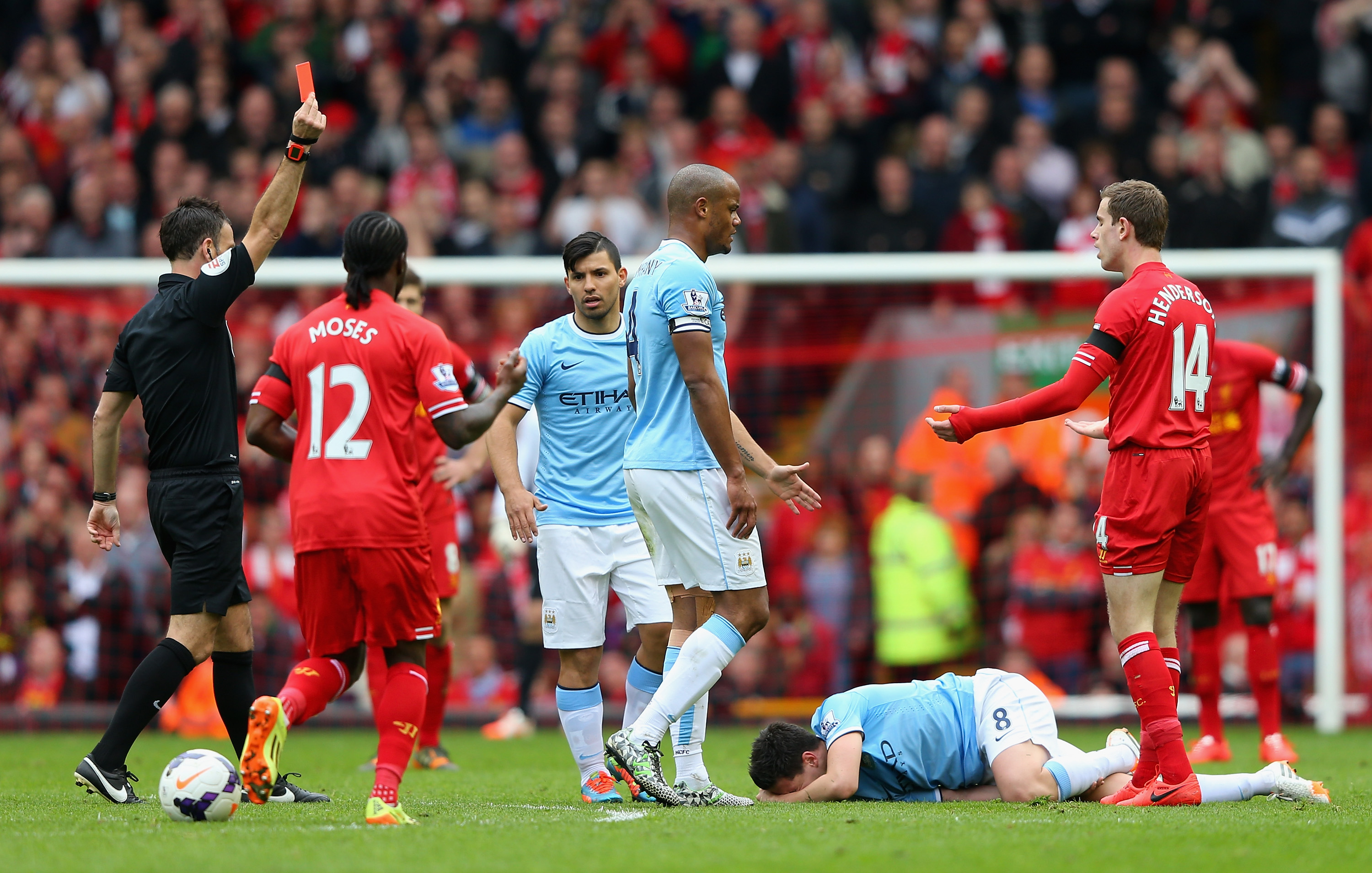 Mark Clattenburg shows a red card to Liverpool's Jordan Henderson against Manchester City in 2014