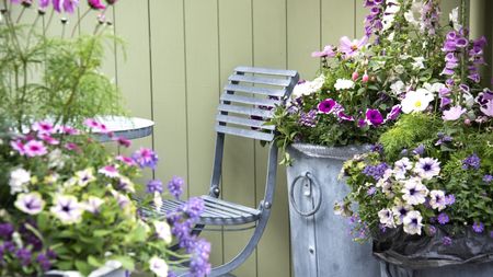 Seating area surrounded by planters in bloom