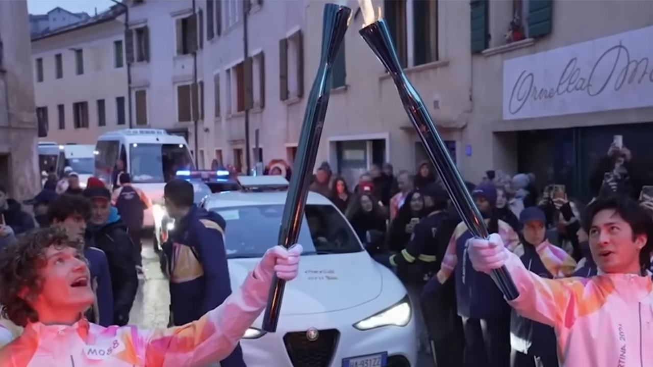 Connor Storrie on the left holding up his torch alongside Hudson Williams