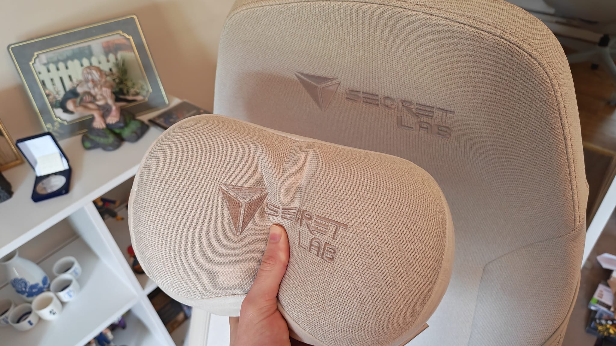 A reviewer pushing into the neck pillow on the Secretlab Atlas