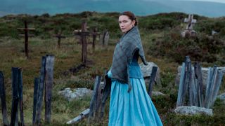 Lib Wright (Florence Pugh) stands alone in a graveyard in The Wonder