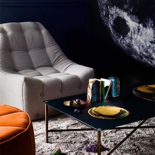 white chair gold cratered coffee table moon rock