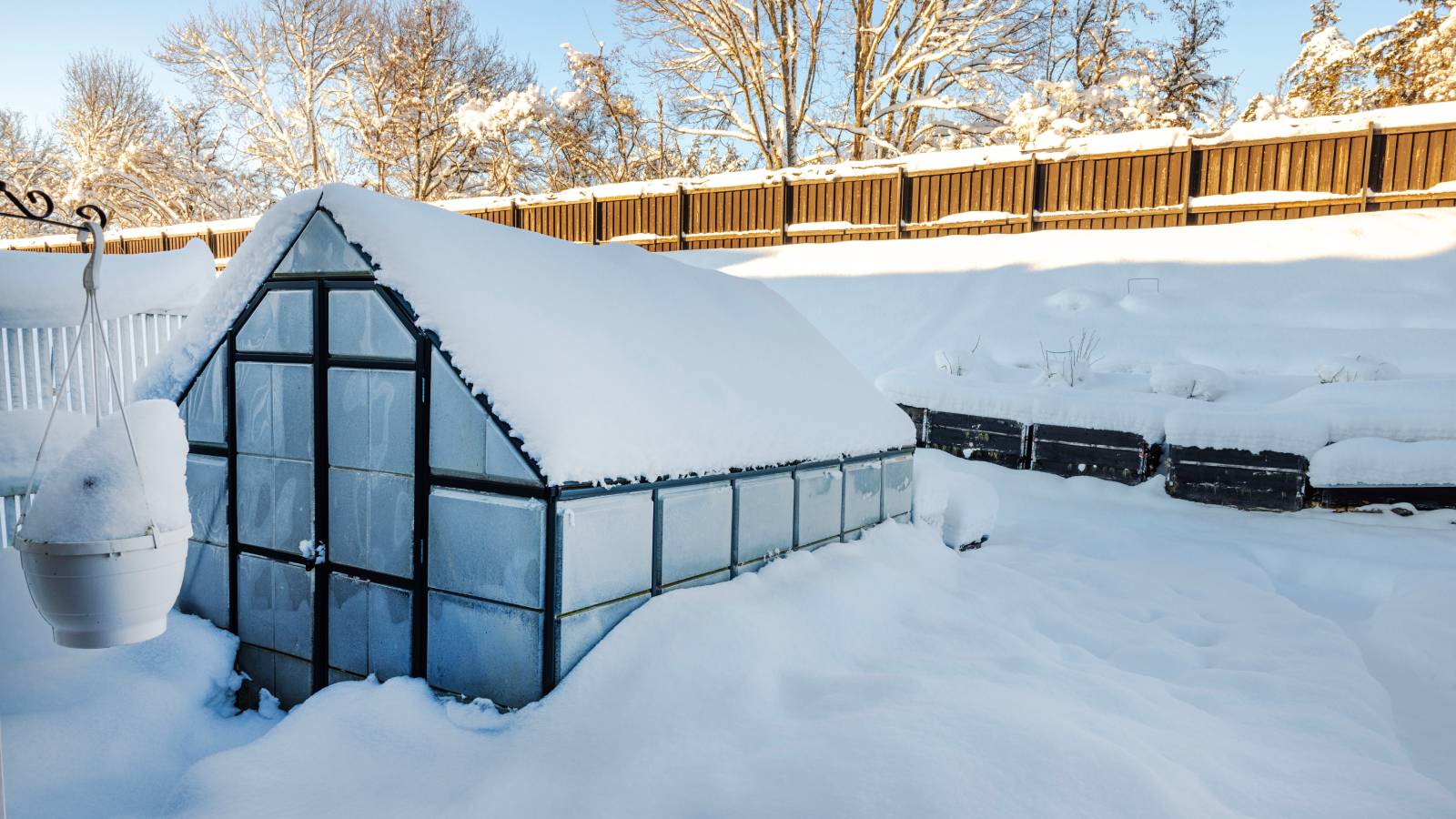 A greenhouse surrounded by deep snow