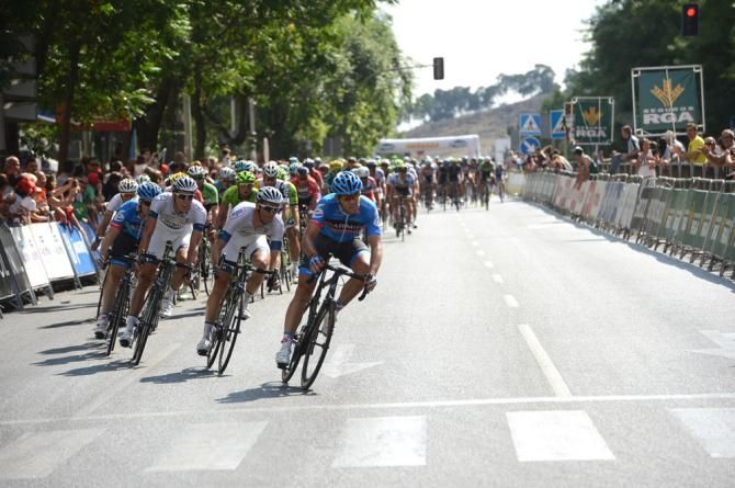 Garmin-Sharp leads the peloton through the final turn, just seconds behind Tony Martin.