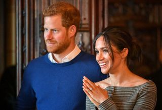 Prince Harry and Meghan Markle watch a performance by a Welsh choir in the banqueting hall during a visit to Cardiff Castle