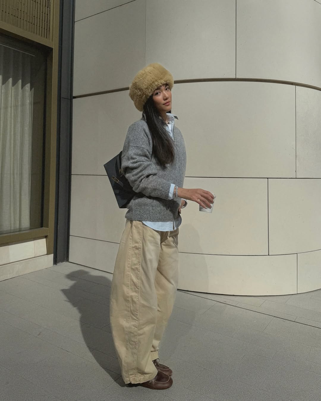 Woman wearing layering outfit idea 2026.