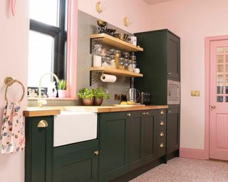 two-tone color contrast kitchen scheme with pink walls and black cabinets