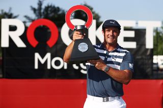 Bryson DeChambeau holds the Rocket Mortgage Classic trophy after his win in 2020