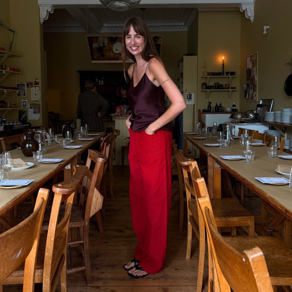 An image of @lizzyhadfield wearing one of the best shoe colours to wear with red jeans.