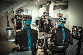 Kenny Elissonde sips his cappuccino with Tim Kerrison in the background making the coffee