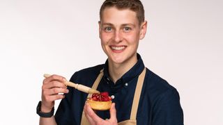 Peter Sawkins poses with a pastry brush and a pastry.