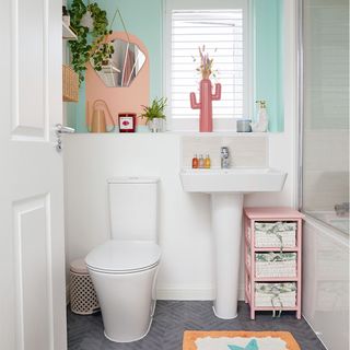 white tiled bathroom with mint green painted wall