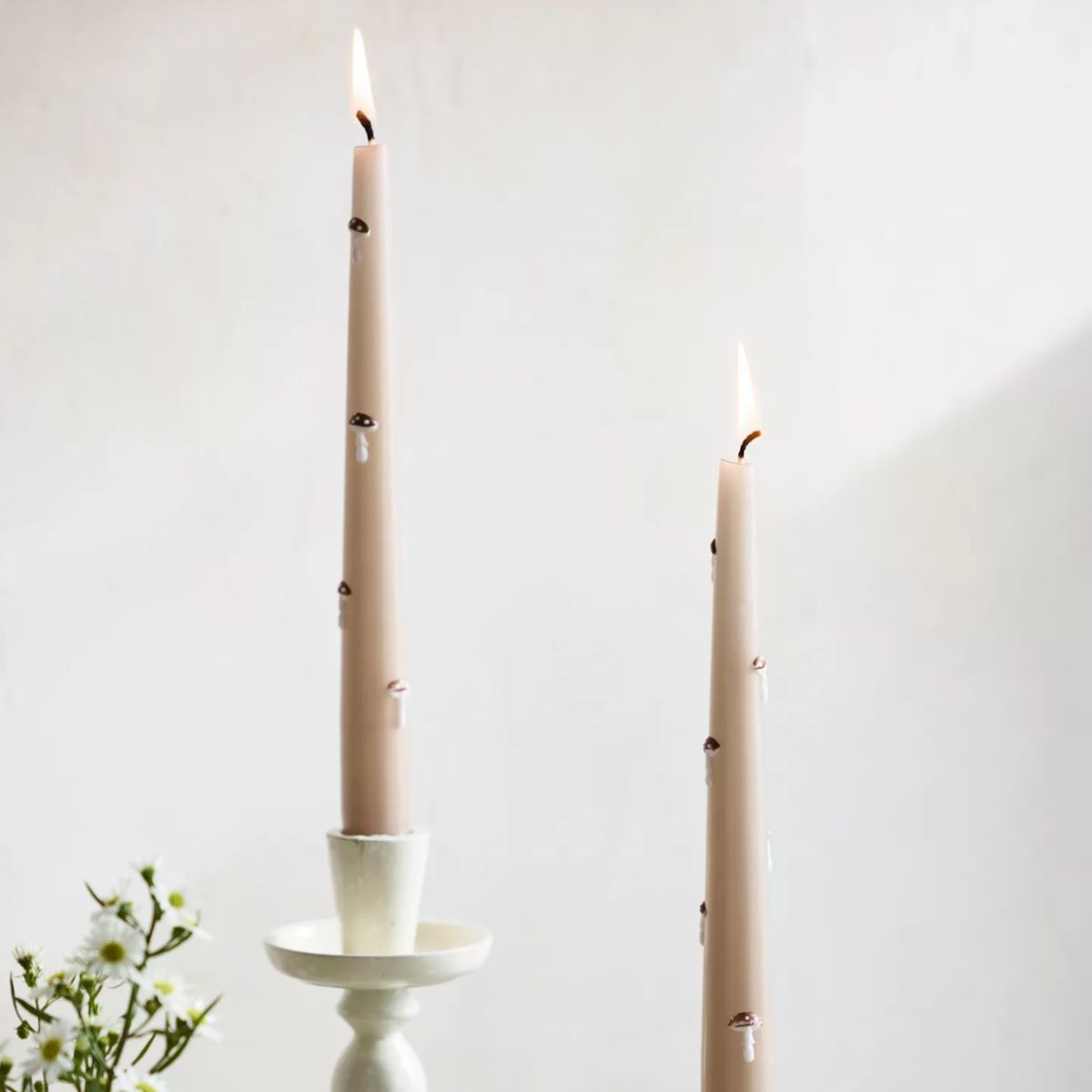 Two mushroom colored dinner candles