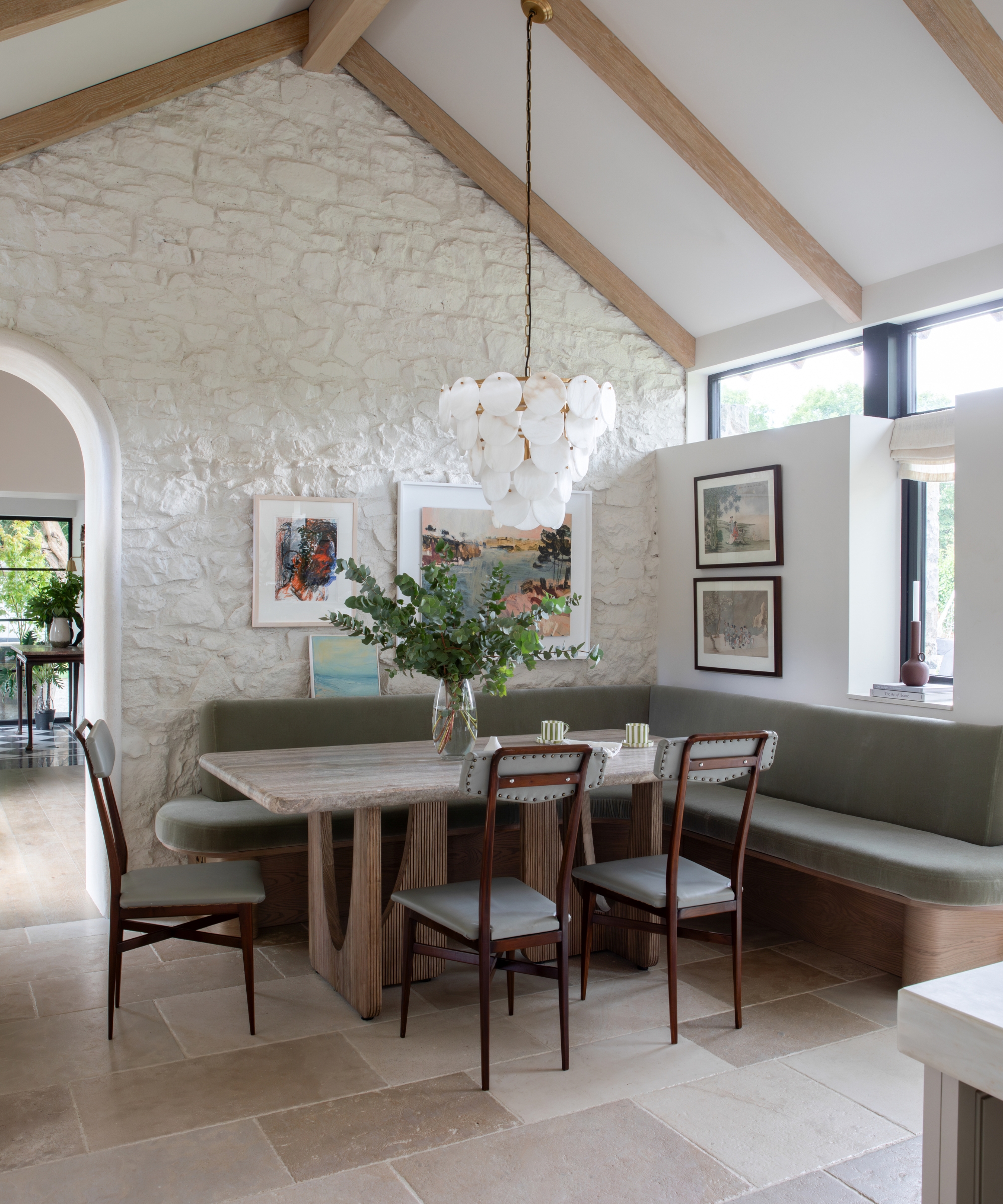 A kitchen banquette with exposed stone walls