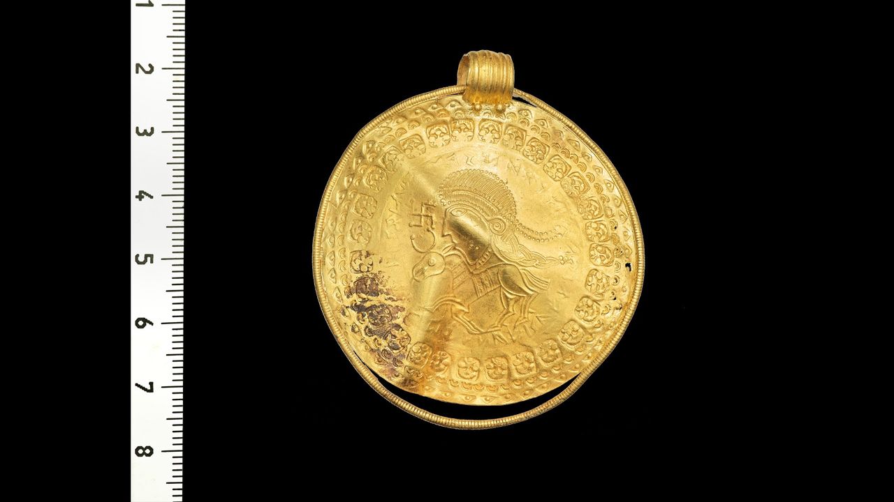 The bracteate &ndash; a pendant stamped on a thin piece of gold &ndash; features an inscription in runic letters that reads "He is Odin's man" in an early form of the Norse language.