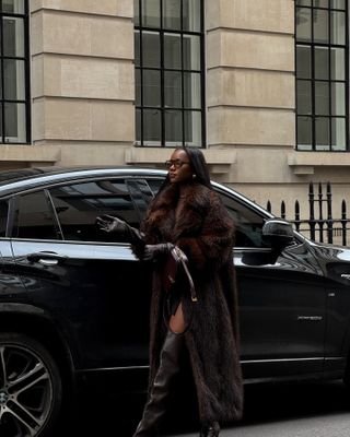 Influencer wears a faux fur coat.