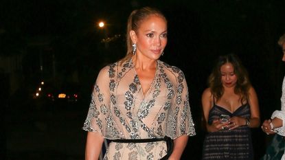 Jennifer Lopez wearing a sheer gown with black heels and a beaded purse for her 55th birthday in the Hamptons July 2024