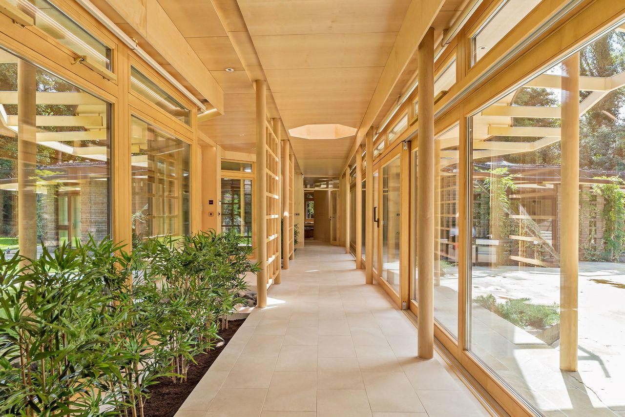 The hallway in the home is made of glass linking it to the garden