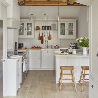 kitchen with wooden flooring and white cabinets