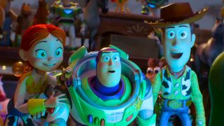Jessie, Buzz and Woody look at a screen glowing in the dark