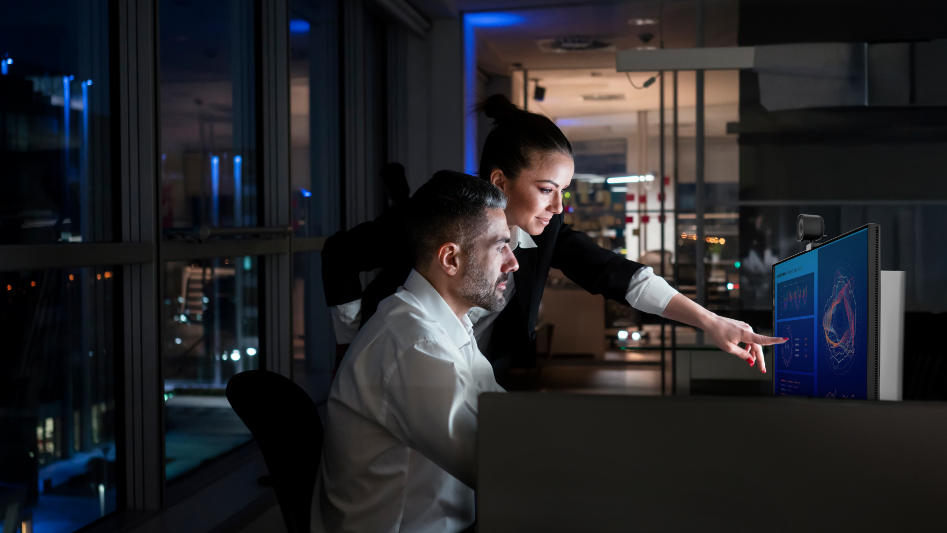 Dell AI Data Platform: two people working late at night in an office at the same monitor, discussing a problem