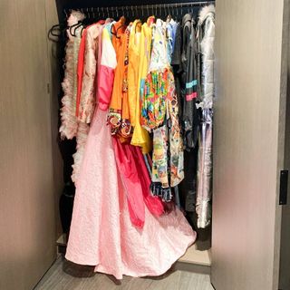 Closet with colorful clothes hanging up