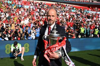 Manchester United manager Erik ten Hag holding the FA Cup