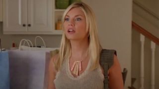 Elisha Cuthbert in the kitchen standing near shopping bags as Alex on Happy Endings.