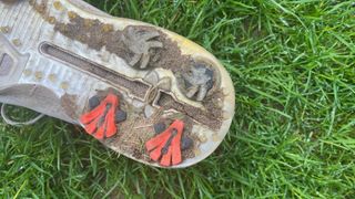 Broken spikes on the outsole of a golf shoe