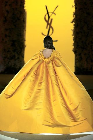 Evening gown with long cape in yellow