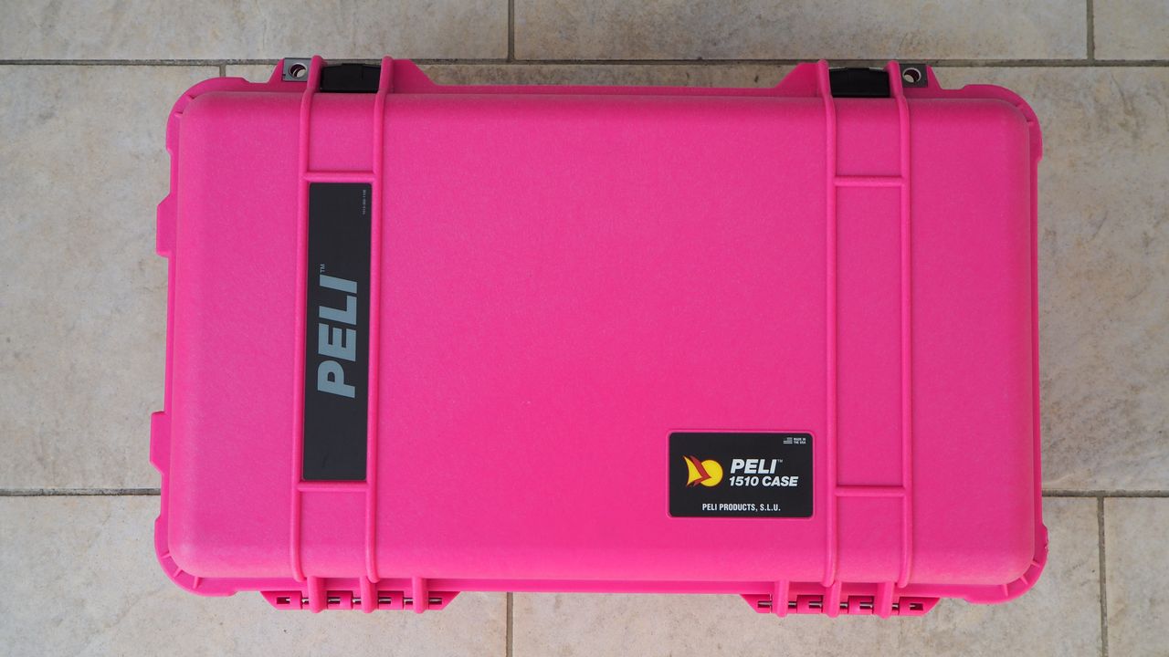 Peli / Pelican 1510 protector case in bright pink on a flagstone floor
