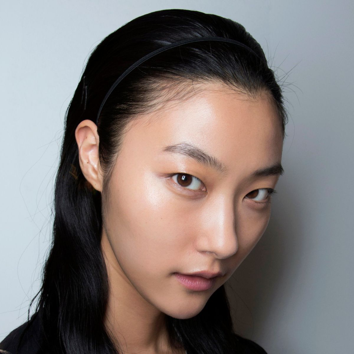 a model with super glowy skin backstage at Barbara Bui - medicube