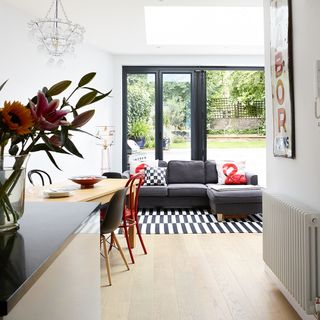 sitting area with grey sofa and garden view