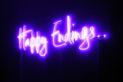 A glowing neon sign with the words "Happy Endings" in glowing letters.