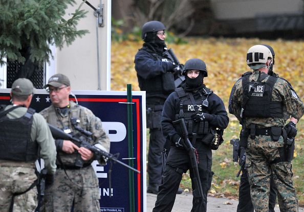 Police outside the home of alleged police shooter Scott Michael Greene.